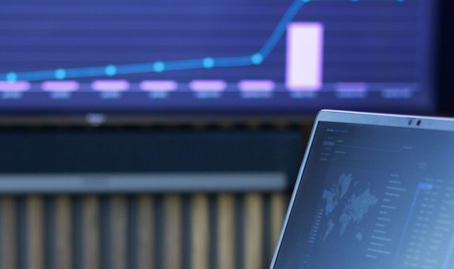 Laptop displaying dashboards from Monitor ERP system.