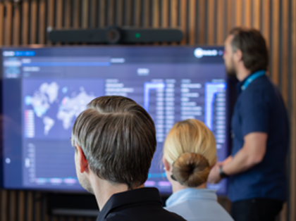 A man at Monitor ERP giving a presentation to a group of people about Monitor BI (business intelligence)