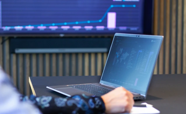 laptop on a table showing Monitor ERP Dashboard