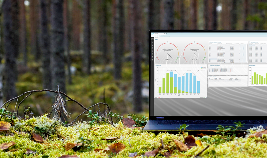 A laptop computer with Monitor ERP dashboard (sustainability functions) sitting on top of a moss covered field.