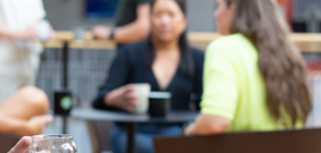 A woman sitting in front of a group of people.