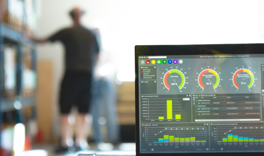 Monitor ERP dashboard displayed on a laptop in a factory environment