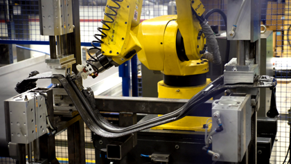 A robot is working on a piece of machinery.