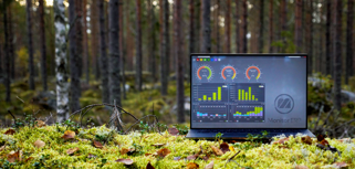 Illustration av Monitor ERP:s instrumentpaneler på en skärm placerad i naturen, som symboliserar hållbarhet.