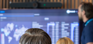 A man at Monitor ERP giving a presentation to a group of people about Monitor BI (business intelligence)