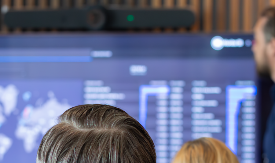 A man at Monitor ERP giving a presentation to a group of people about Monitor BI (business intelligence)