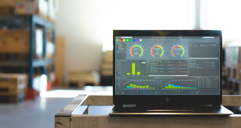 Monitor ERP dashboard displayed on a laptop in a factory environment