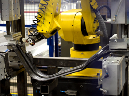 A robot is working on a piece of machinery.