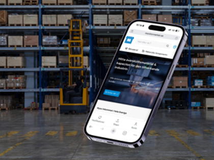A cell phone in the middle of a warehouse.