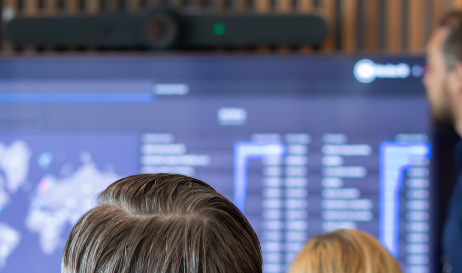 A man at Monitor ERP giving a presentation to a group of people about Monitor BI (business intelligence)