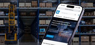 A cell phone in the middle of a warehouse.