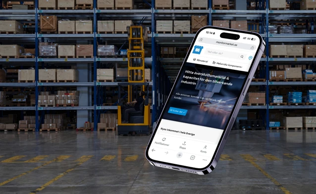 A cell phone in the middle of a warehouse.