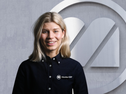 A woman standing in front of a sign that says online demo.