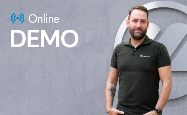 A man with a beard standing in front of a sign.